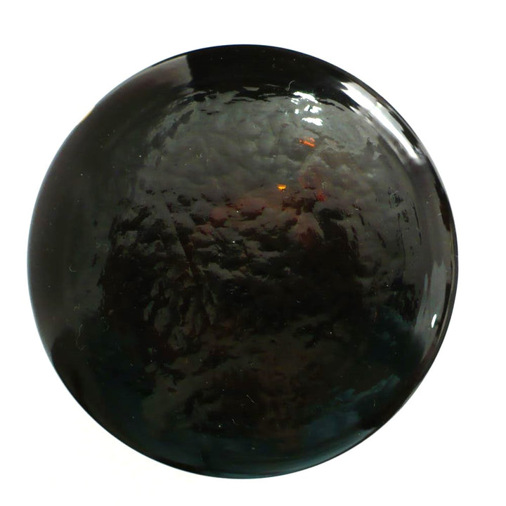 19th-century hand-blown amber glass apothecary jar with a label indicating it once contained cardamon seed powder. The jar has a dark amber color, a narrow neck, and a round stopper. Stopper top.