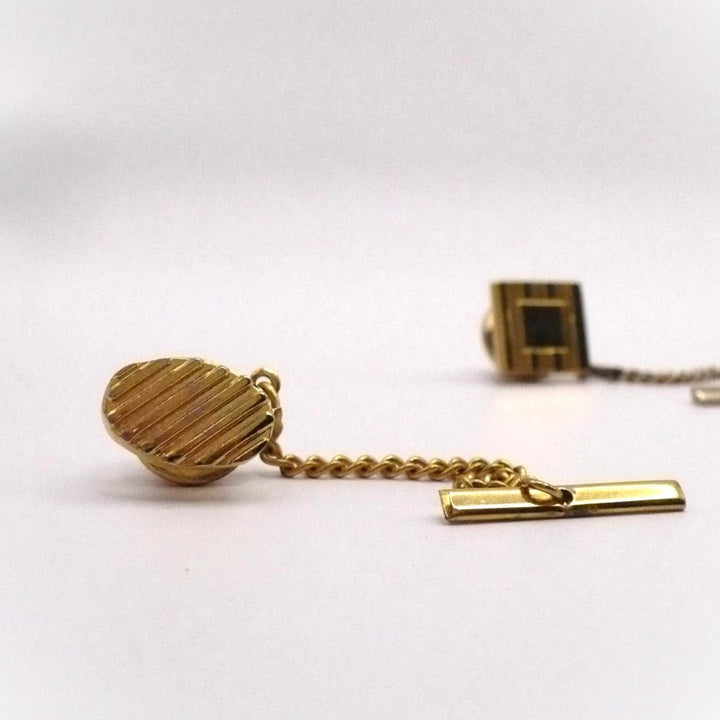 Vintage tie tack with chain and bar.