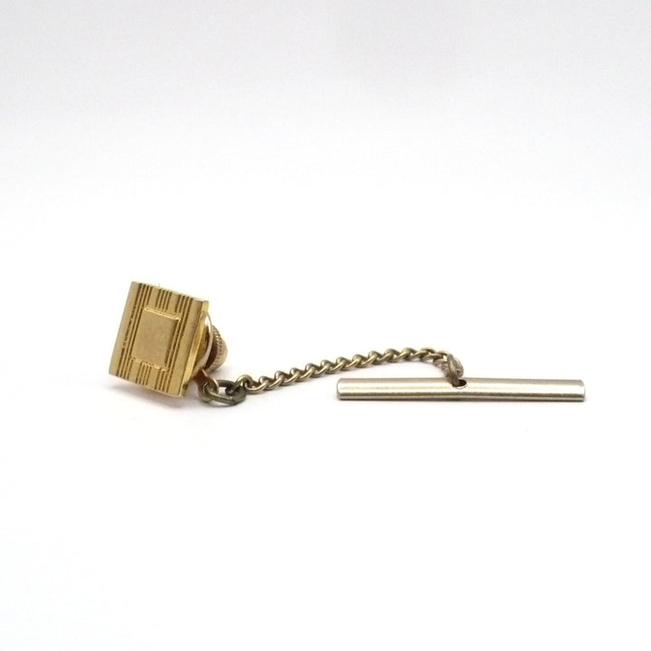 Vintage tie tack with chain and bar.