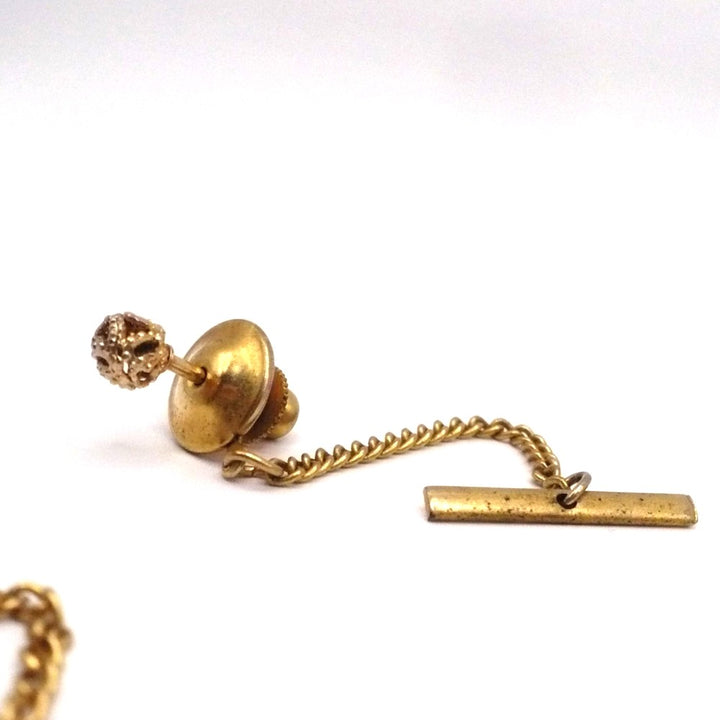 Vintage tie tack with chain and bar.