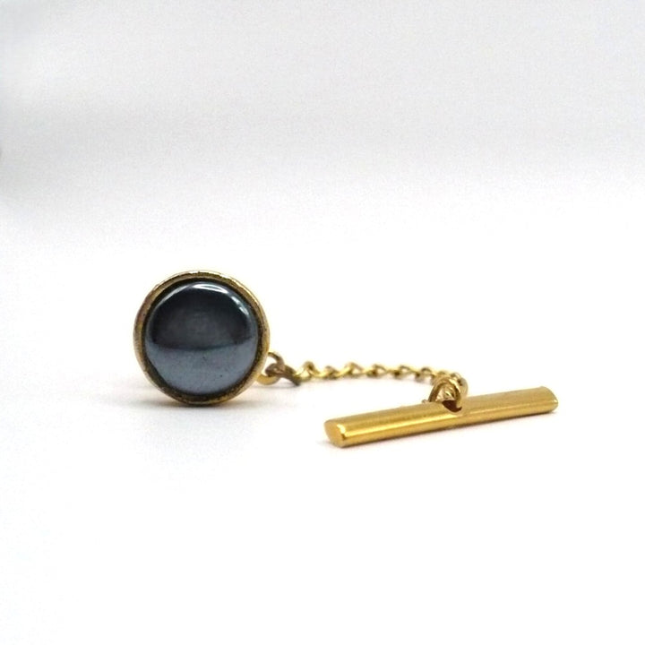 Vintage tie tack with chain and bar.