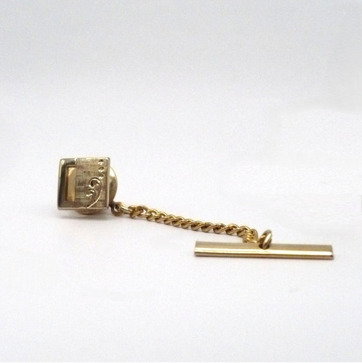 Vintage tie tack with chain and bar.