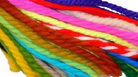 A close-up of a selection of colorful collection of vintage yarn hair ties available at Get Lucky Vintage