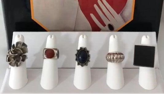 A collection of vintage rings styled across different fingers on a hand, illustrating ring finger meanings and symbolism.