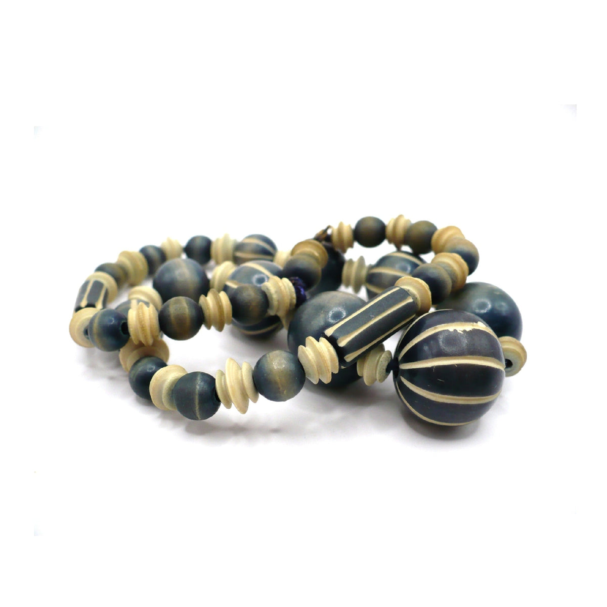 1970s vintage beaded necklace featuring blue-grey and cream striped wood beads and carved camel bone spacers.