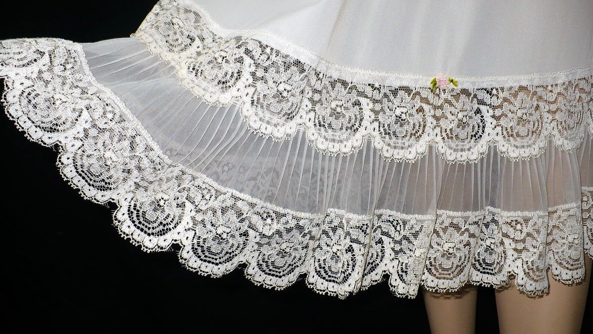 Vintage lingere main category image of gorgeous white lace trim at slip hem.
