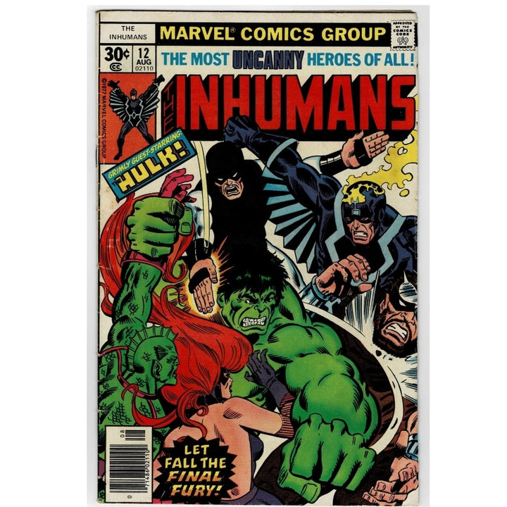 Vintage Marvel Comics Group Inhumans comic book, issue number 12 from August, featuring a colorful cover illustration with the green Hulk, black-robed antagonist, and red-haired character on a cream background.