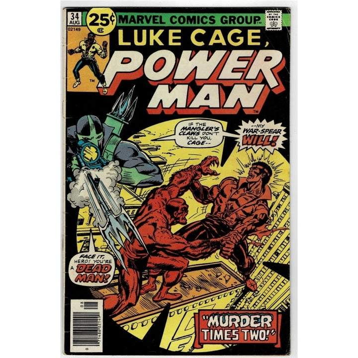 A vintage comic book, Marvel Comics Group's Luke Cage, Power Man #34 from July, featuring a cover illustration of Luke Cage in red fighting a green and black villain with a silver war-spear. The comic is photographed flat against a white background.