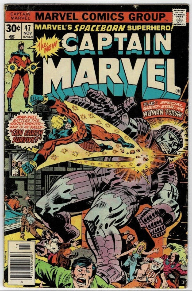 Captain Marvel #47 comic book cover from Marvel Comics Group, featuring a dynamic illustrated battle scene with a large metallic gray monster and a superhero in red and blue, with prominent title text and issue pricing.