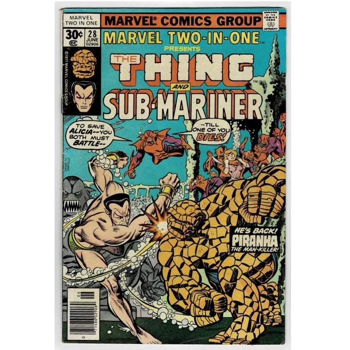 Vintage comic book cover for Marvel Two-In-One #28, featuring The Thing and Sub-Mariner in an action scene. The cover has a black border with colorful comic artwork, including a large yellow-orange rock-like character and a muscular figure in the foreground.