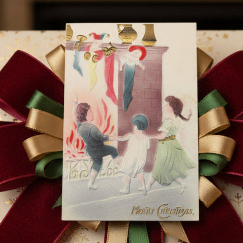 1914 Children Christmas Dancing by the Hearth Vintage Postcard, shown used as a gift topper.