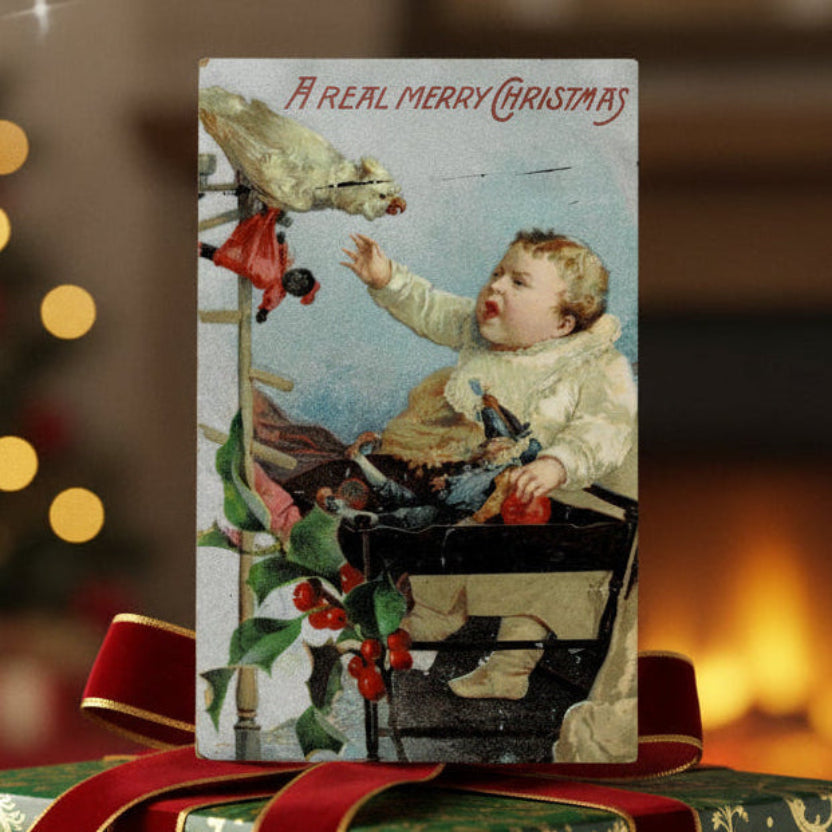 1909 Bird vs. Baby: Holiday Edition Vintage Christmas Postcard, shown used as a gift topper.