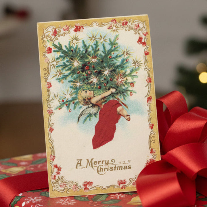 1910 Angel of Love Delivers Christmas Tree Vintage Christmas Postcard surrounded by red ribbons, gift topper.