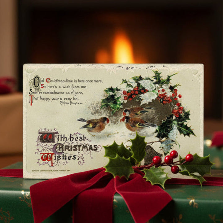 1911 Old Christmas-time by Winsch Vintage Christmas Postcard on a gift with red ribbon, fireplace in the background.