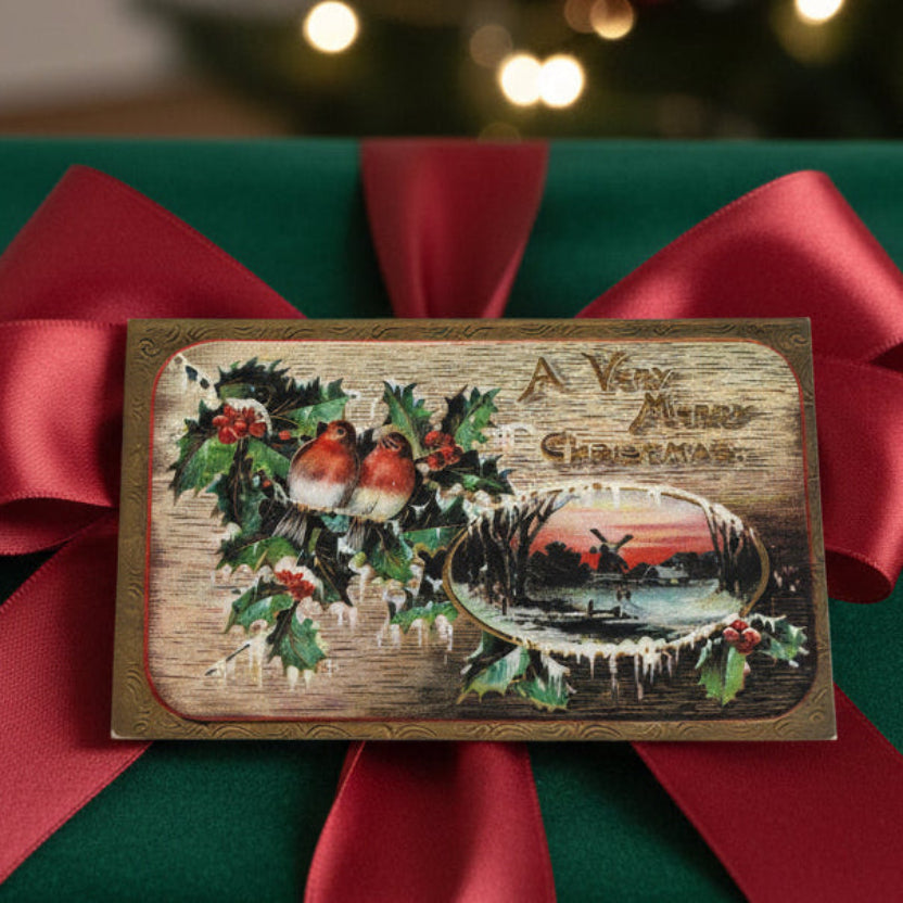 1911 Songbirds in the Snow Vintage Christmas Postcard on a decorative ribbon as a gift topper.