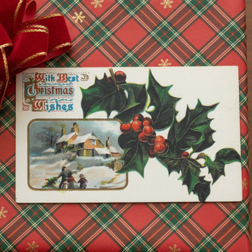 1909 Holly and Family Bringing Home Tree Vignette Vintage Christmas Postcard gift topper on a plaid background