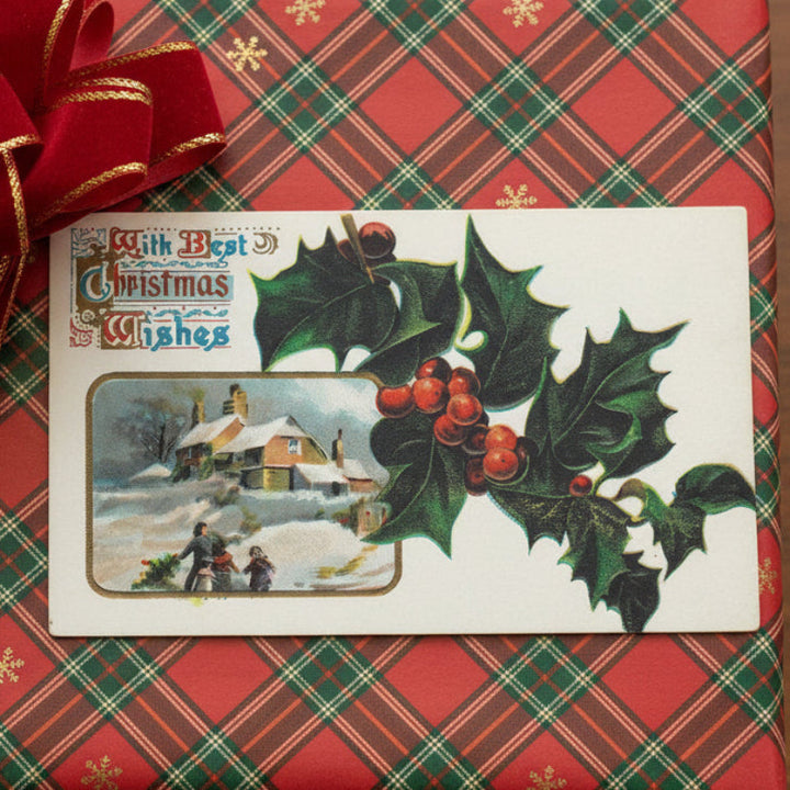1909 Holly and Family Bringing Home Tree Vignette Vintage Christmas Postcard gift topper on a plaid background