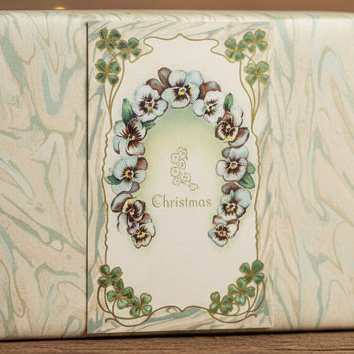 1911 Christmas Wishes with Irish Charm Vintage postcard,  shown as a gift topper.