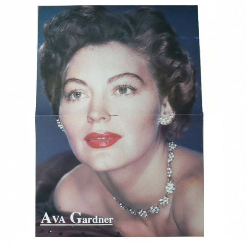 Vintage centerfold poster of Ava Gardner with jewelry on a blue background.