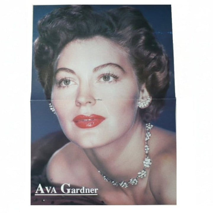 Vintage centerfold poster of Ava Gardner with jewelry on a blue background.