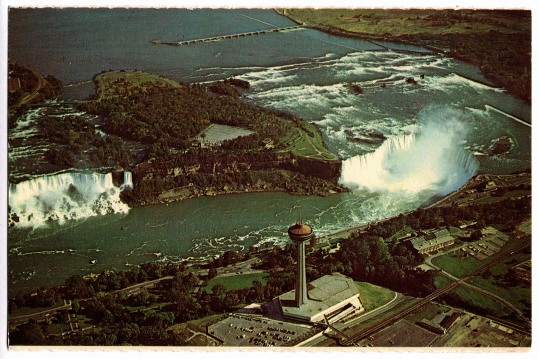 Aerial view of Niagara Falls with a prominent water structure in the foreground vintage postcard.