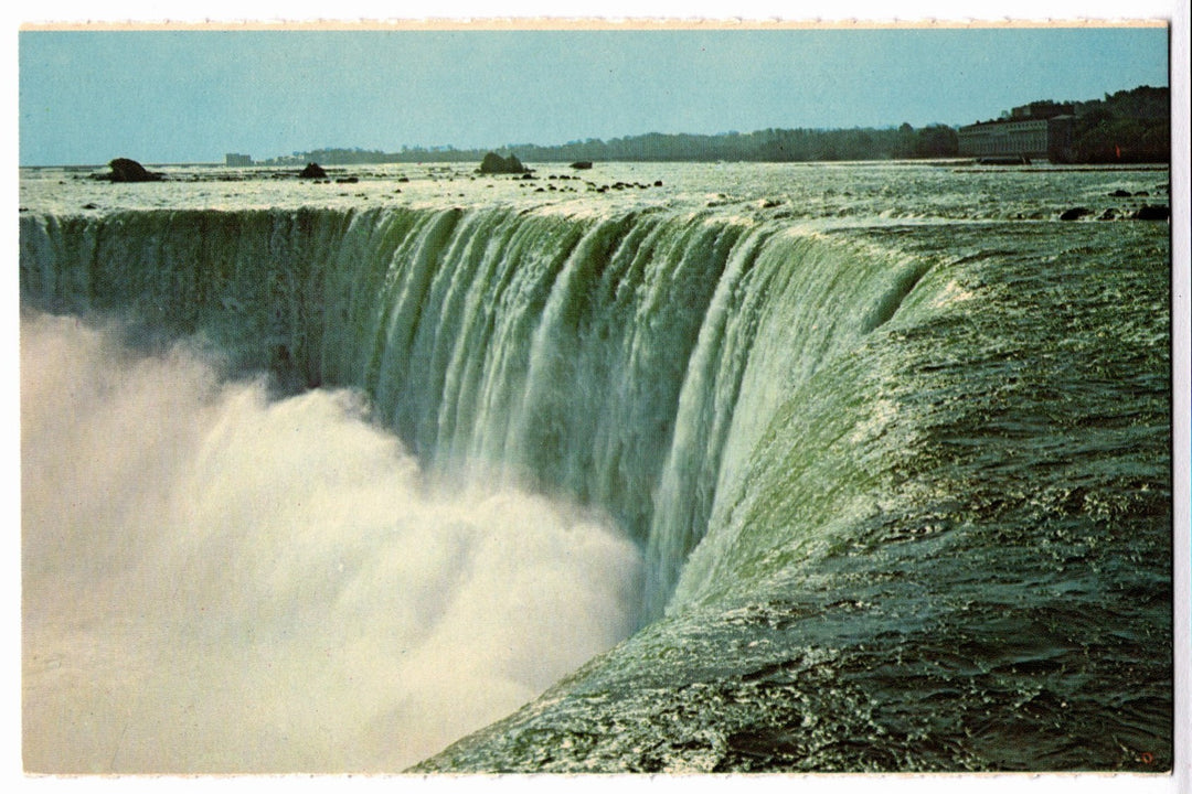 Niagara Falls with water cascading over the edge vintage postcard.