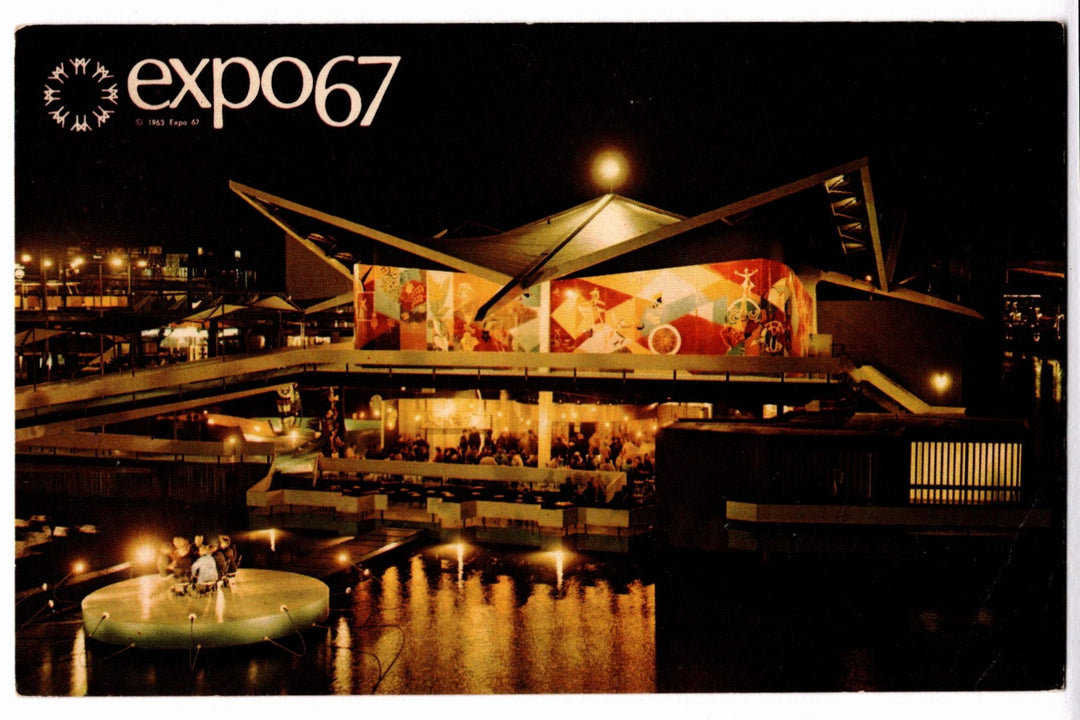Expo 67 pavilion at night with illuminated sign and architectural design.