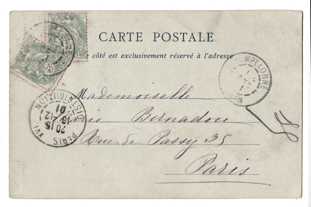 Vintage French postcard with stamps and cursive writing on a white background