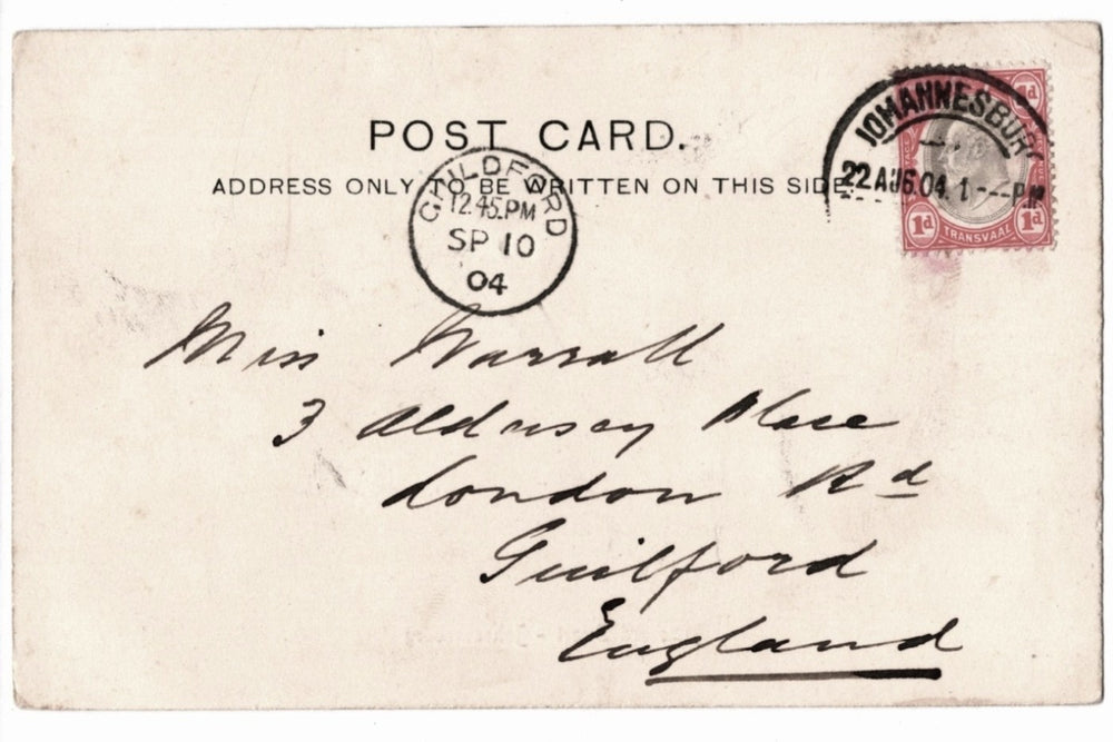 Vintage postcard with postage stamp and handwritten address, featuring a red stamp and black text.