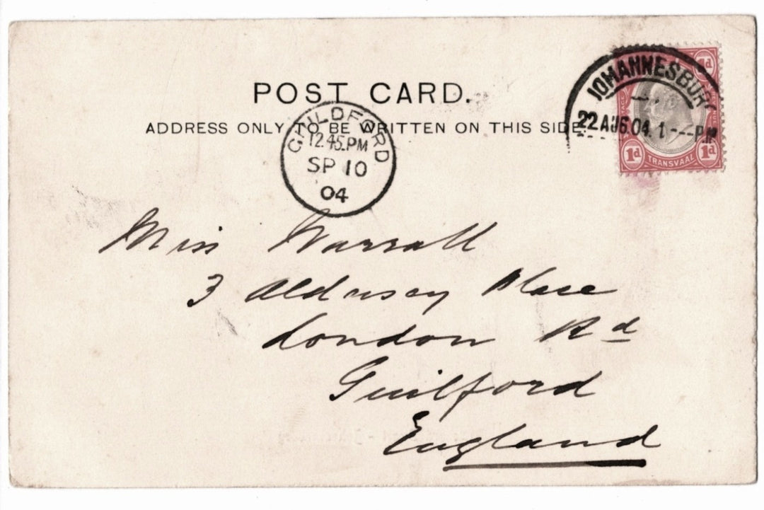 Vintage postcard with postage stamp and handwritten address, featuring a red stamp and black text.