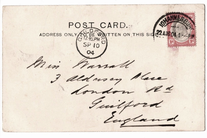Vintage postcard with postage stamp and handwritten address, featuring a red stamp and black text.