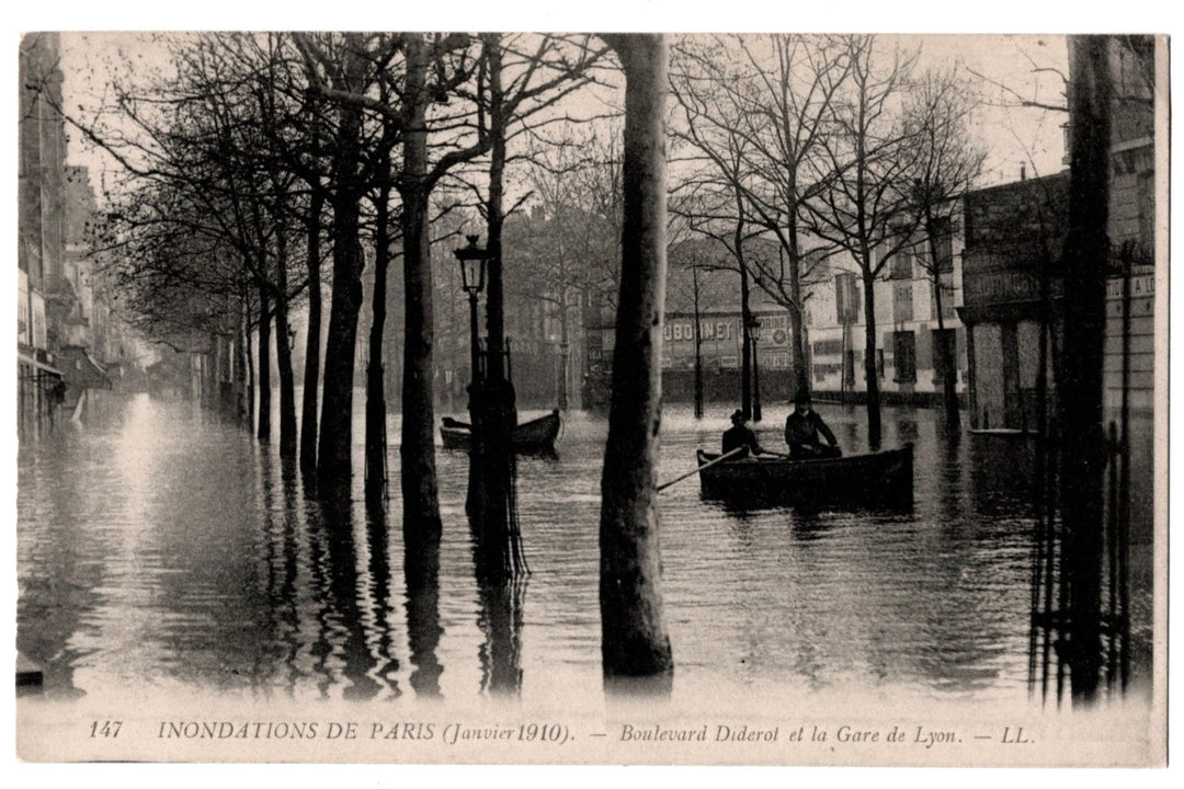 Flooded street with people in boats in Paris, January 1910. 1910 Great Flood of Paris France Gare de Lyon Vintage Postcard.