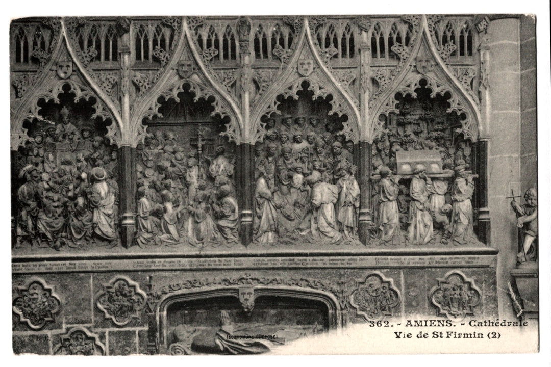 Decorative stone panel with religious scenes in a cathedral, featuring intricate carvings.