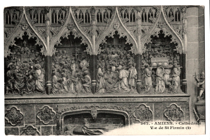 Decorative stone panel with religious scenes in a cathedral, featuring intricate carvings.