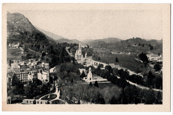 Vintage black and white photo of a scenic landscape with buildings and mountains. 1905 Lourdes France Sanctuary Calvary France Vintage Postcard.