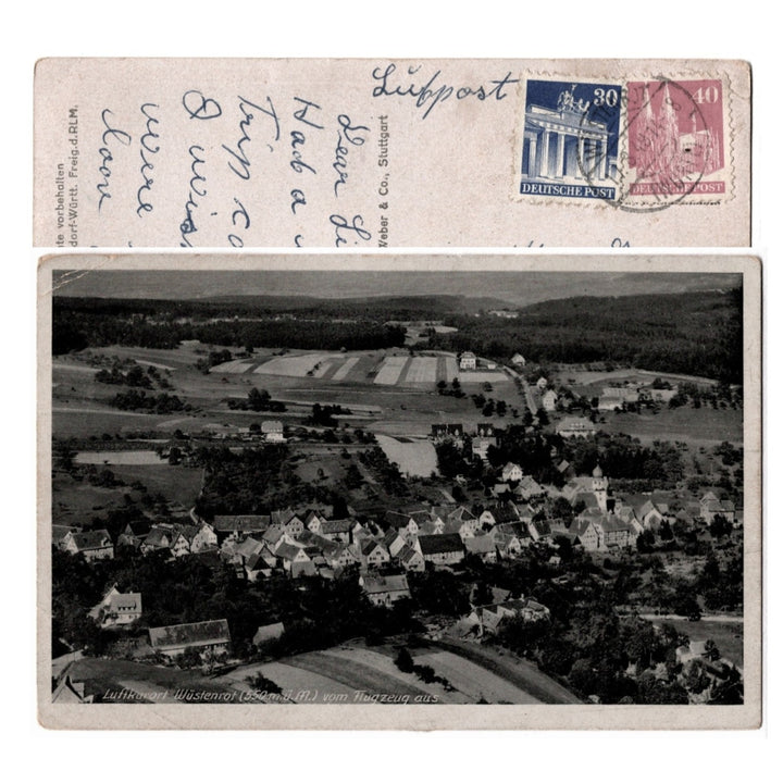 Vintage postcard with aerial view of a village and German postage stamps.