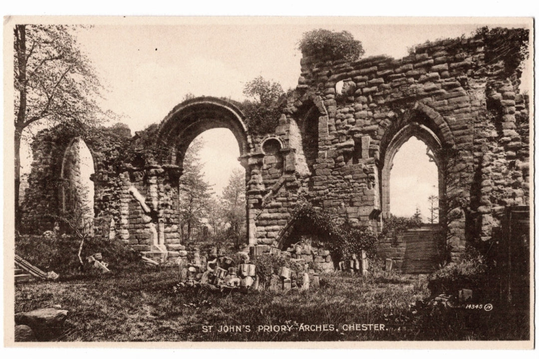 Ruins of St. John's Priory Arches in Chester, showing stone arches and overgrown grass.