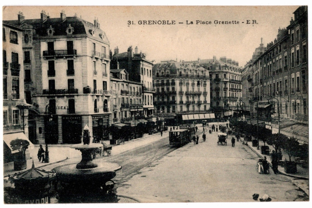 Vintage street scene in Grenoble with buildings and a fountain.