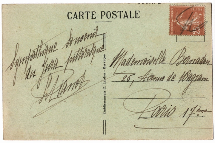 Back of a vintage postcard with text and address lines.