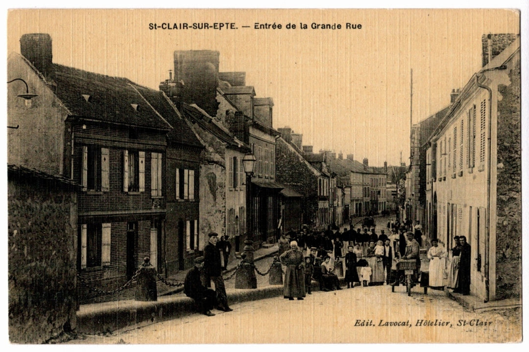 Vintage street scene with people and buildings in a small town, likely from the early 20th century.  1904 Grande Rue Saint-Clair-sur-Epte France Vintage Postcard.