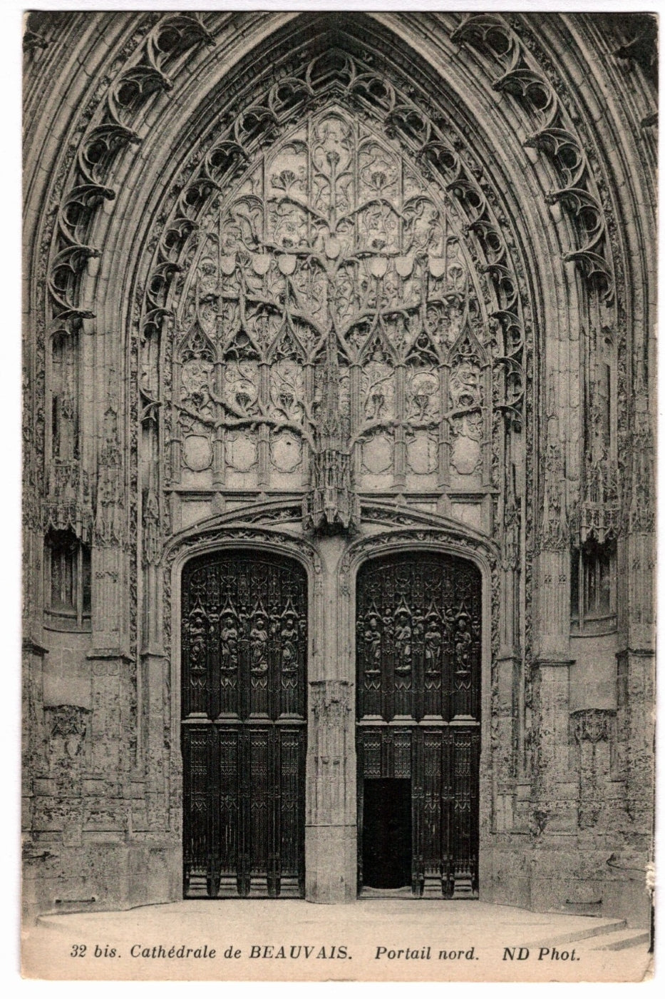 Gothic cathedral portal with intricate carvings in Beauvais, France.