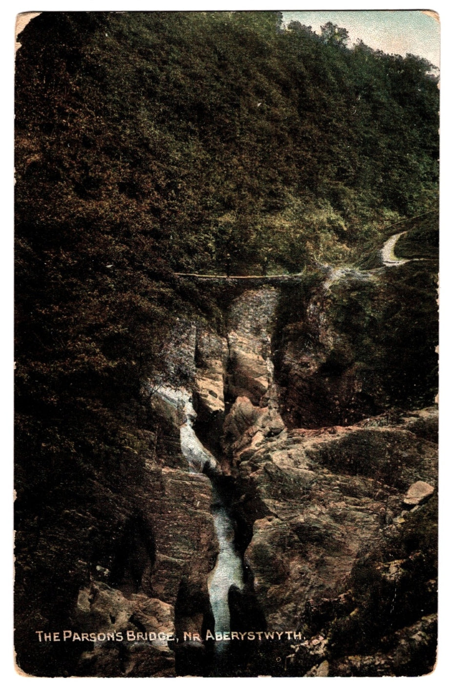 Vintage postcard of a scenic view with a bridge over a waterfall, labeled 'The Parsons Bridge, Na Aberystwyth'.
