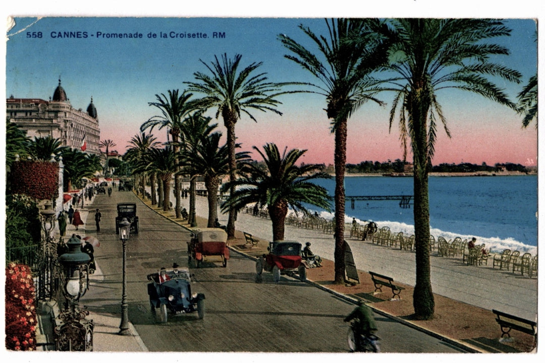 Promenade de la Croisette in Cannes with palm trees and vintage cars on a colorful postcard. 1920 Cannes Promenade de la Croisette Vintage Postcard.