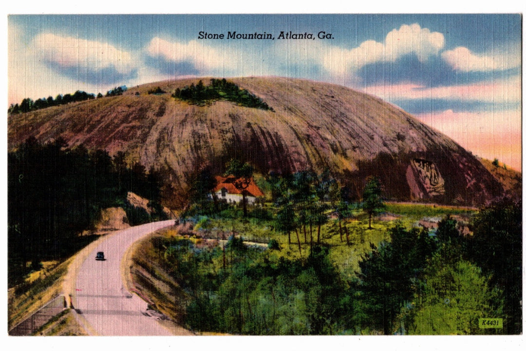 Vintage postcard of Stone Mountain, Atlanta, Georgia with a road and house in the foreground.