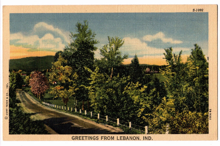 Vintage postcard of a scenic road with trees and mountains, labeled 'Greetings from Lebanon, Ind.'