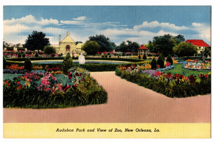 Vintage postcard of Audubon Park and Zoo in New Orleans, featuring a garden with flowers and a path.