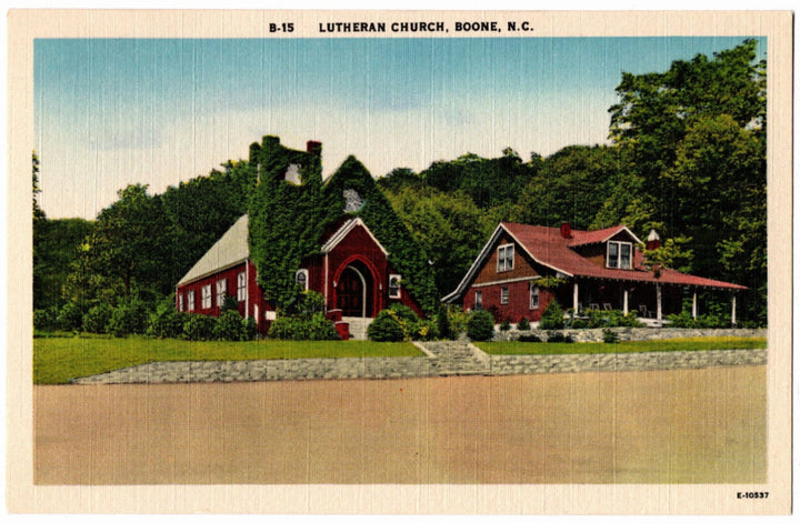 Red Lutheran church in Boone, NC with trees and a clear sky vintage postcard.