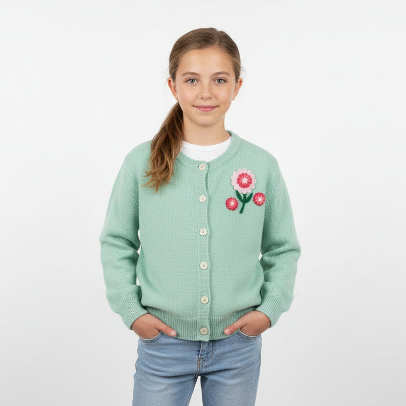 Girl wearing cardigan with1  950-60s Vintage Pink Felt Flower Appliques NOS Postwar Sewing Supply, displayed on sweater, on a white background.