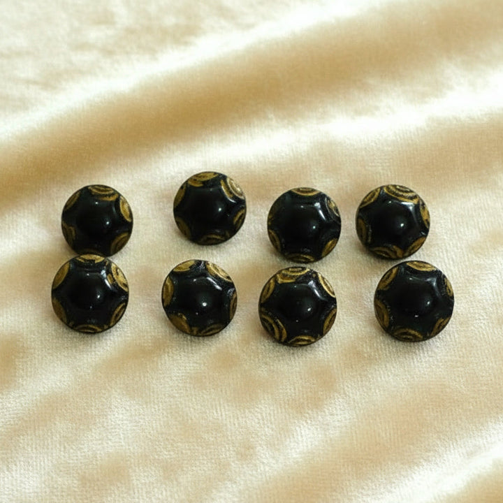 Set of eight 1920s vintage black and gold Art Deco round molded glass diminutive buttons. Round balls with tunnel shanks.