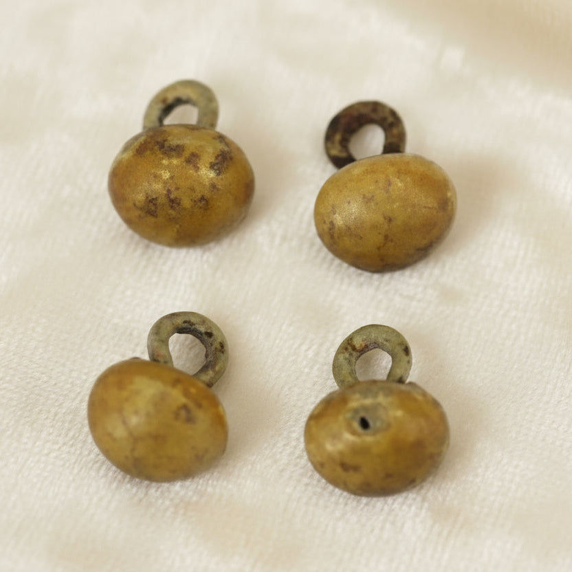 10 Lignes 1/4" Four antique composite ball shoe buttons with metal shanks. 
